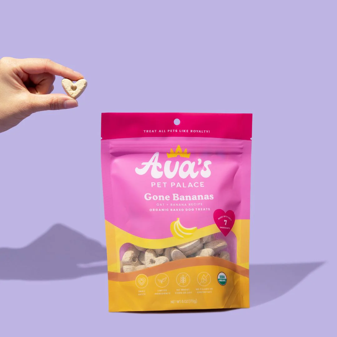 Ava's Pet Palace Gone Bananas organic dog treats package with hand holding a heart-shaped treat