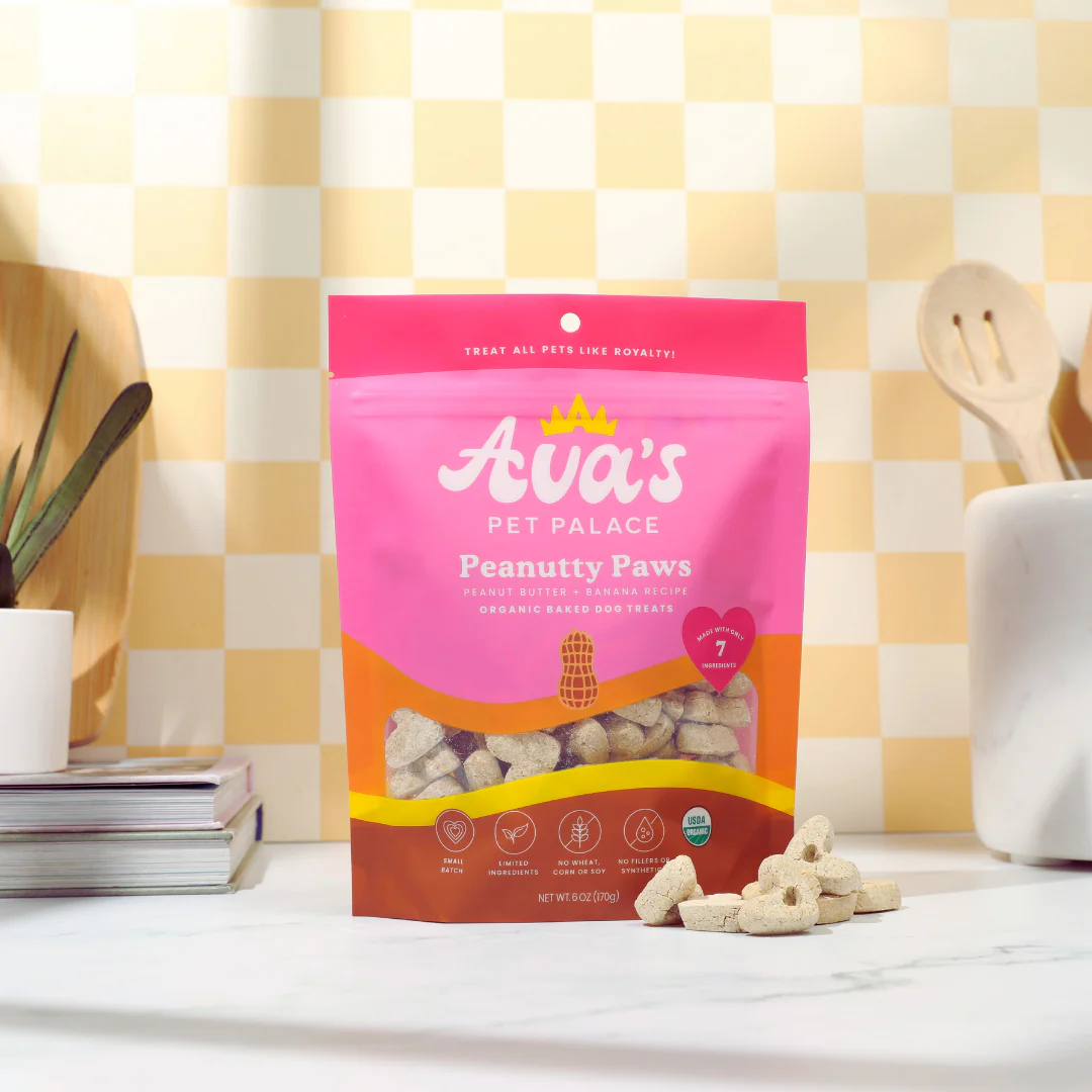 Ava's Pet Palace Peanutty Paws organic dog treats in pink and orange resealable bag on kitchen counter