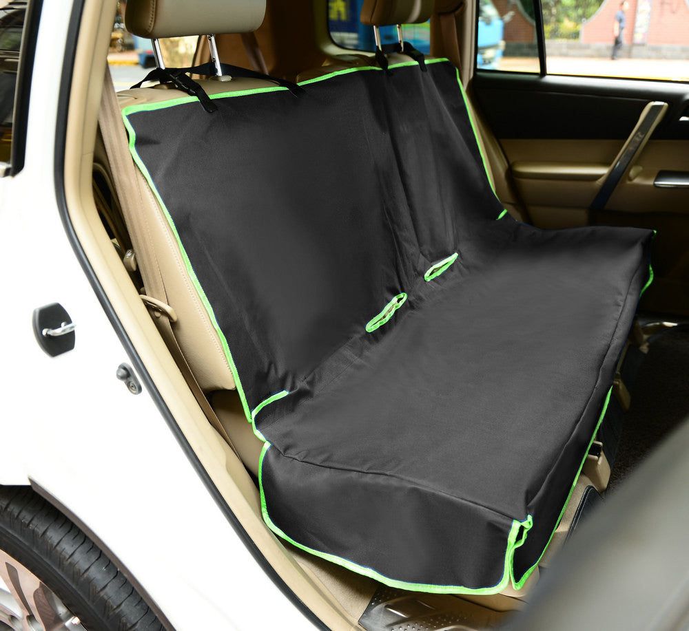 Black pet car seat protector with green trim installed on back seat of a white car