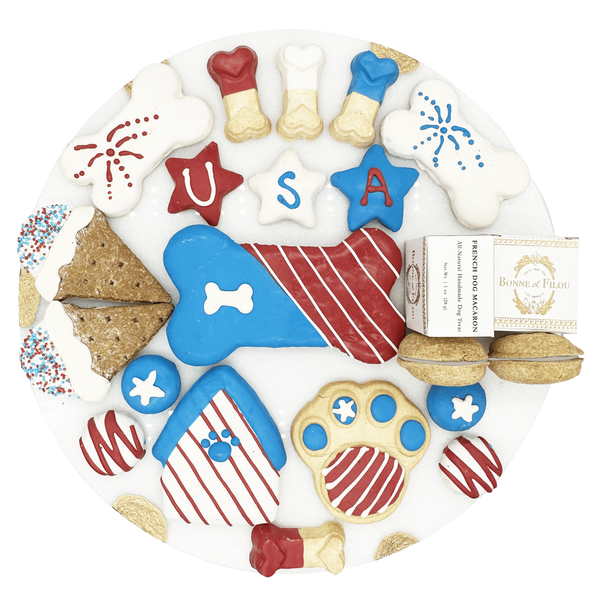 USA themed dog treats in red white and blue colors shaped like bones stars and paws on a white plate