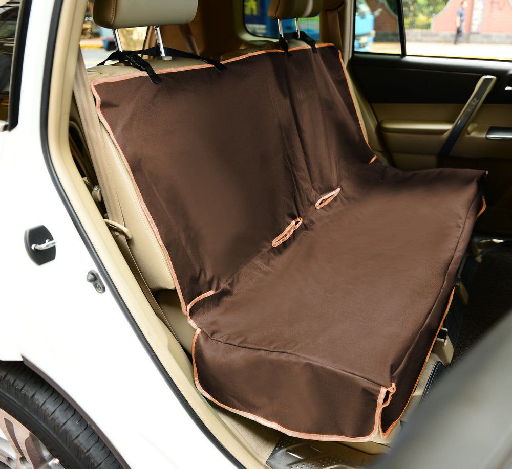 Brown pet car seat protector installed on back seat of a white car to protect upholstery