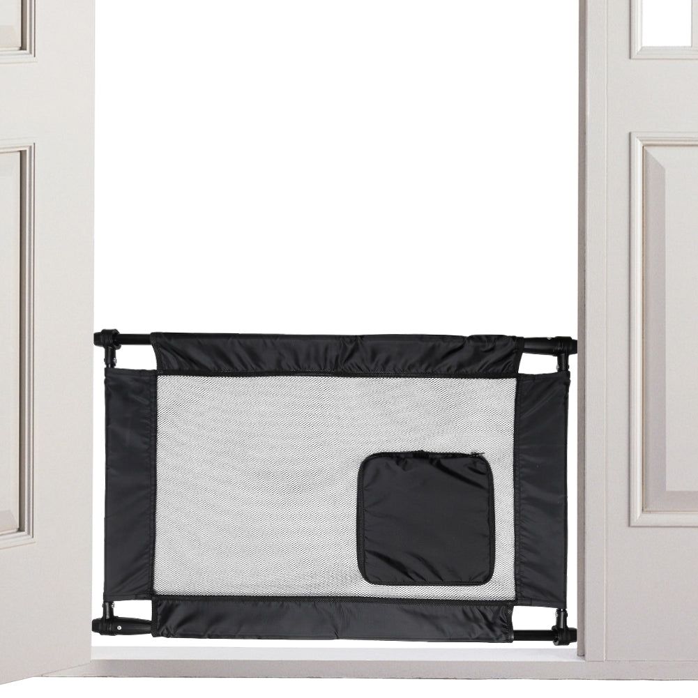 Black and gray collapsible pet gate for travel installed between door frames at home