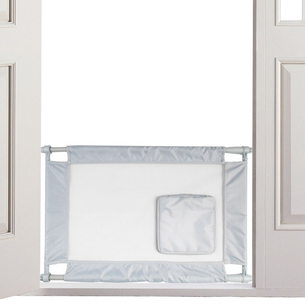 Collapsible pet gate for travel in light gray fabric installed in a doorway with compact foldable design