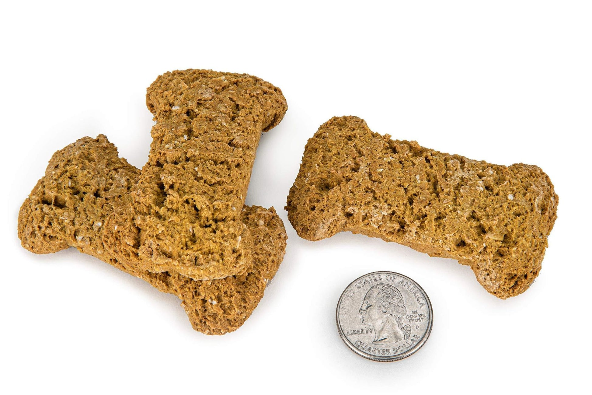 Three all natural dog treats USA in bone shapes next to a quarter for size comparison