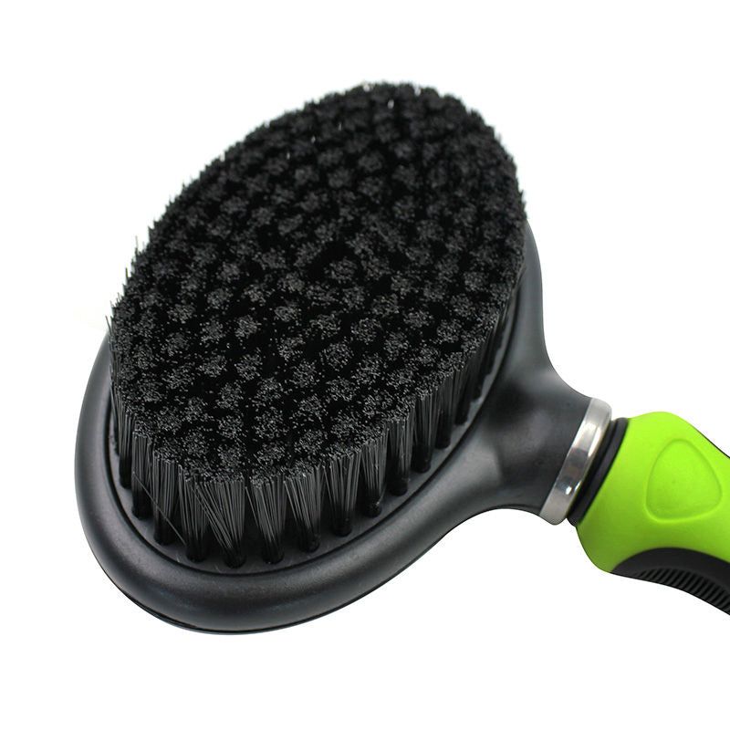 Dual-sided pet grooming brush with black bristles and green handle for effective pet hair removal