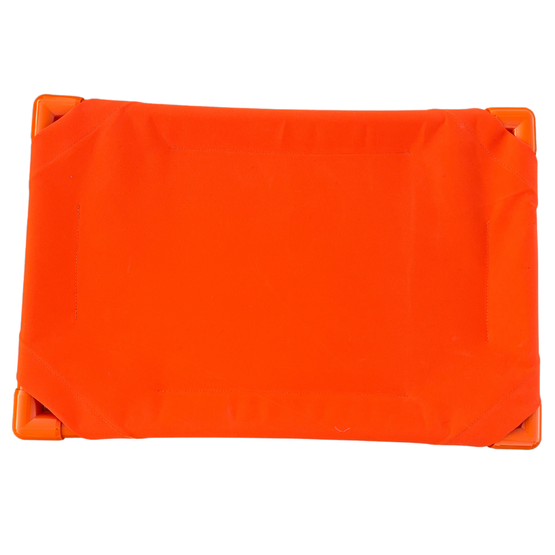 The Family Pet Elevated Dog Bed in bright orange for comfort and support outdoors