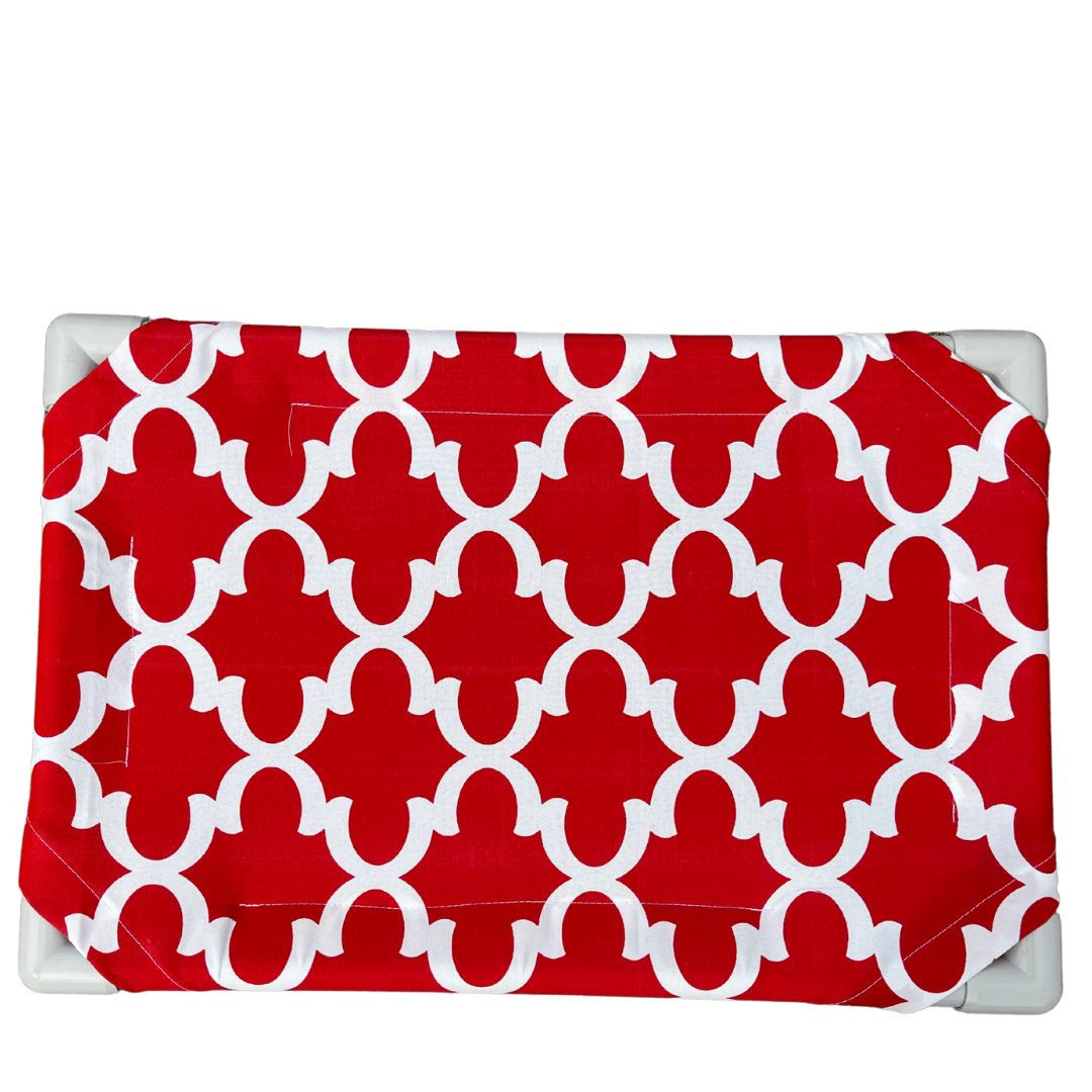 The Family Pet elevated pet bed with red and white geometric patterned fabric cover