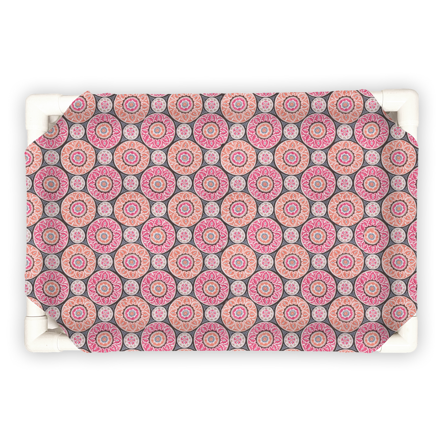 The Family Pet elevated pet bed with pink and gray circular patterned cover on white frame
