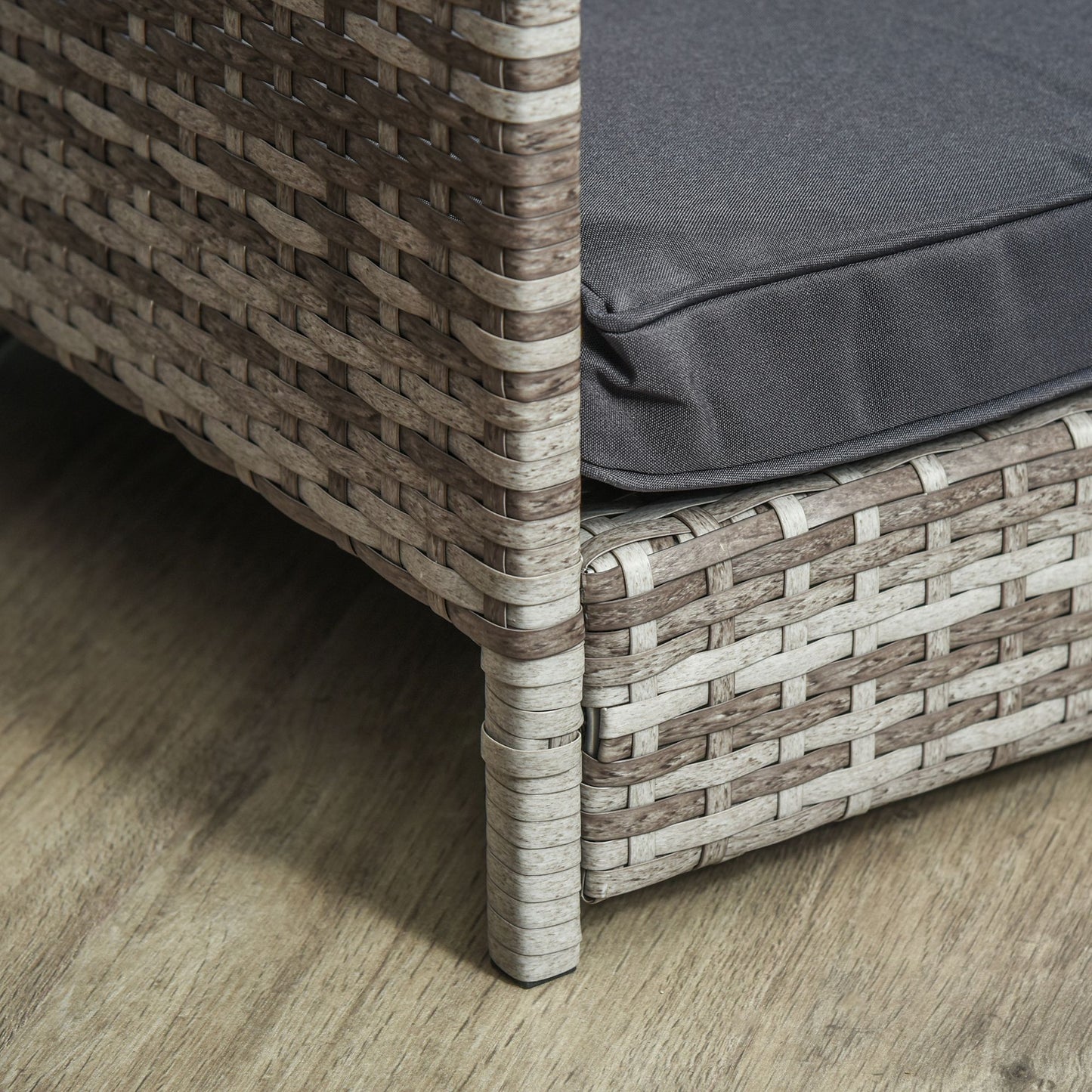 Close-up of PawCounter.com elevated wicker dog house corner with gray cushion on wooden floor