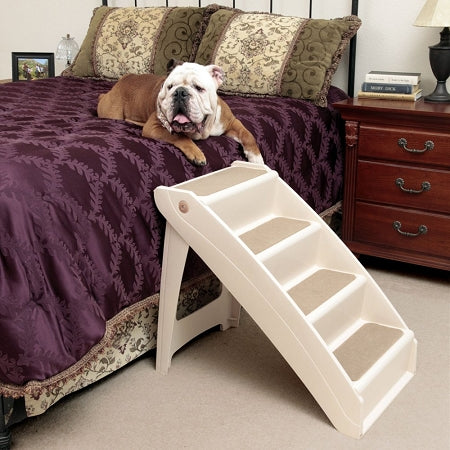 PetSafe extra large dog steps in beige with five wide steps next to bed and bulldog on bed