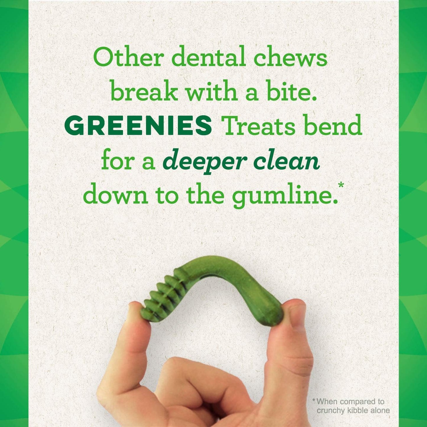 Hand holding a Greenies dental treat for large dogs, designed for a deeper clean down to the gumline.