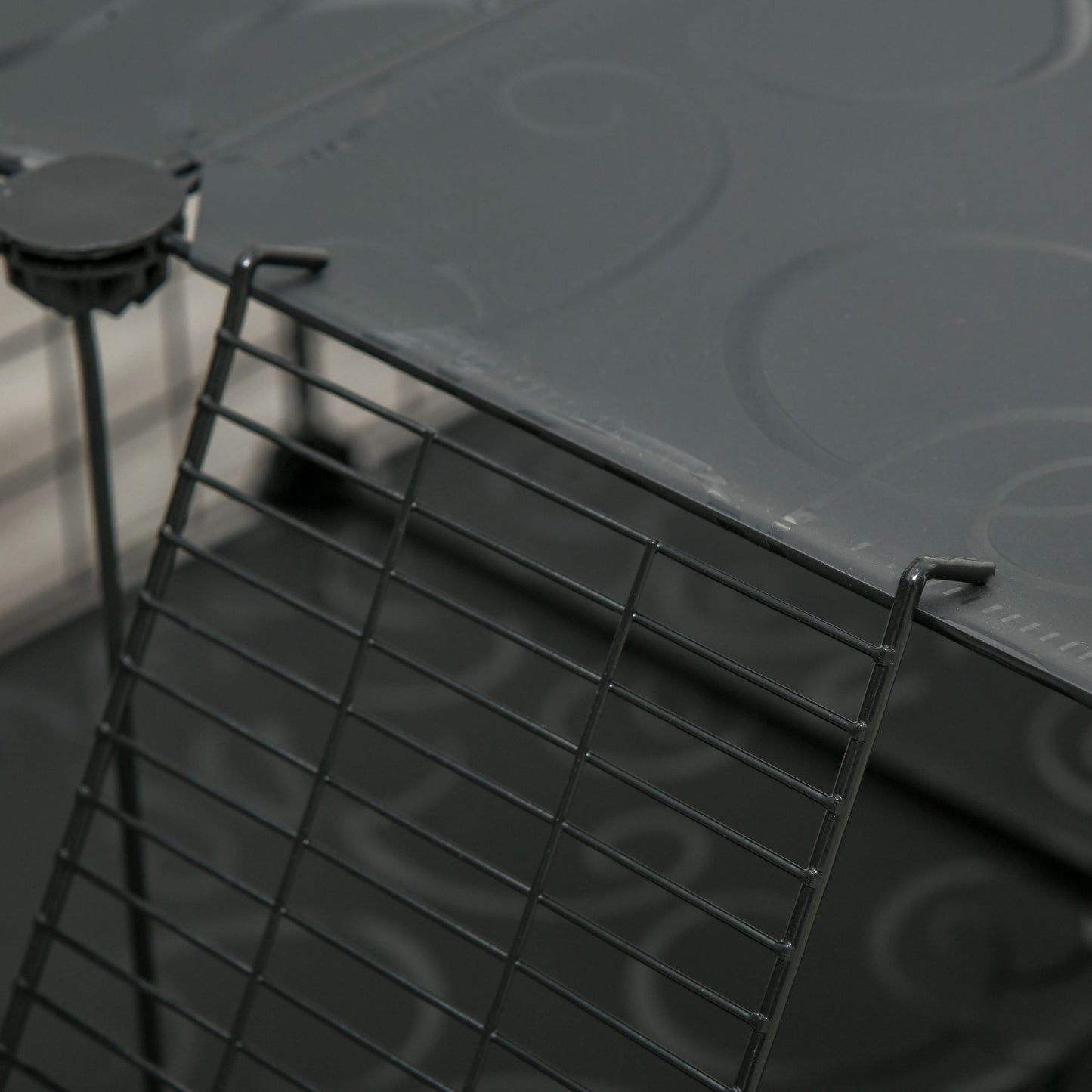 Close-up of guinea pig playpen with door featuring easy-access latch and sturdy design