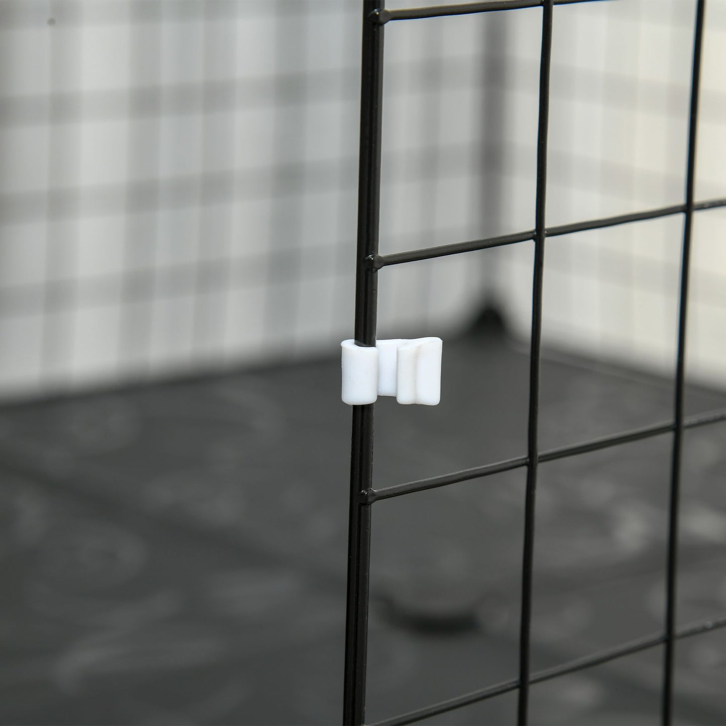 Close-up of a latch on a guinea pig playpen with door, designed for easy access and safety