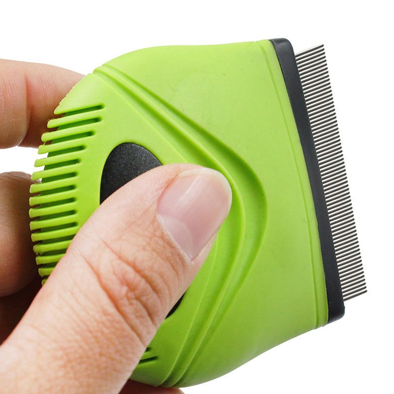 Green handheld flea comb for cats and dogs with fine metal teeth held in hand for grooming