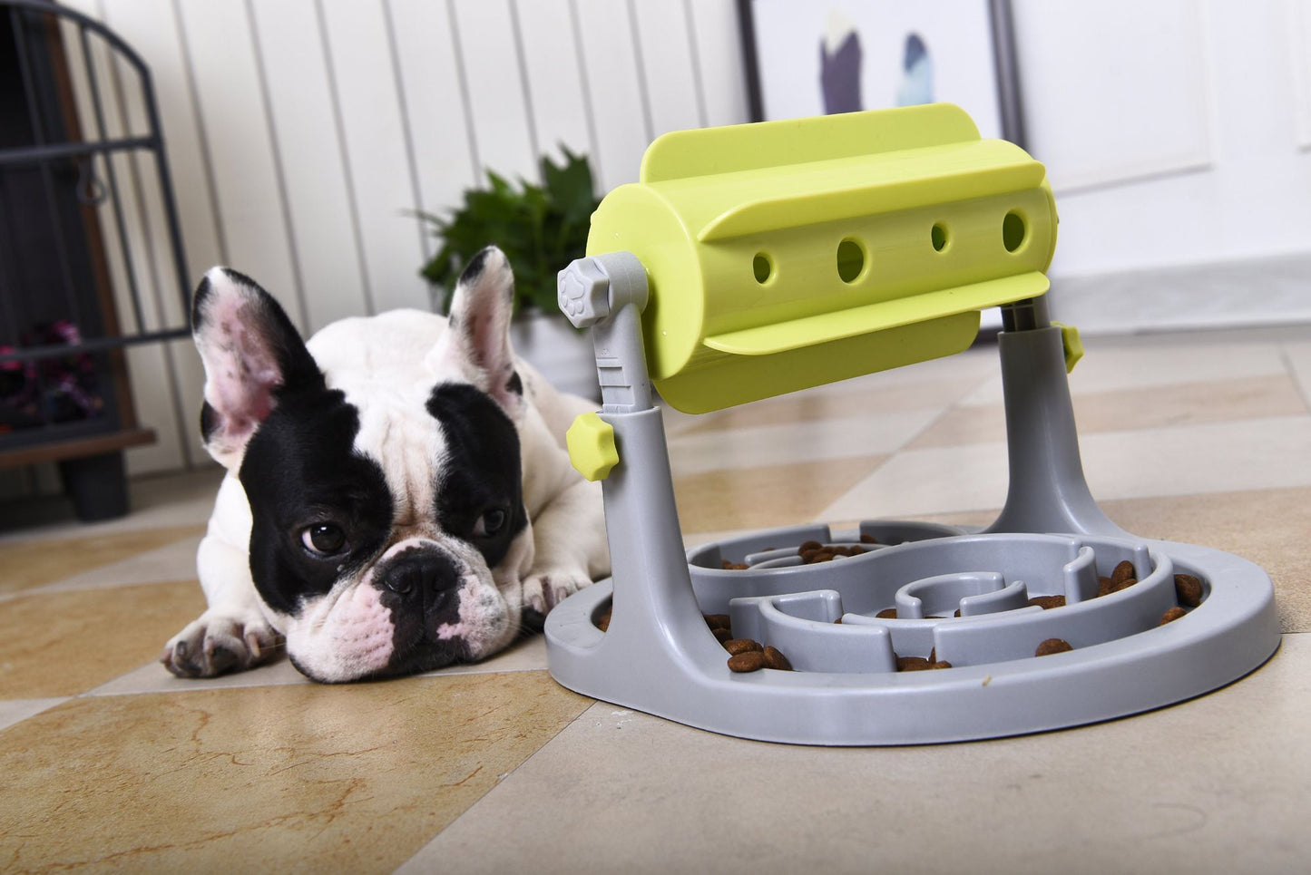 Interactive dog puzzle feeder by PawCounter com with yellow and gray parts and dog lying next to it