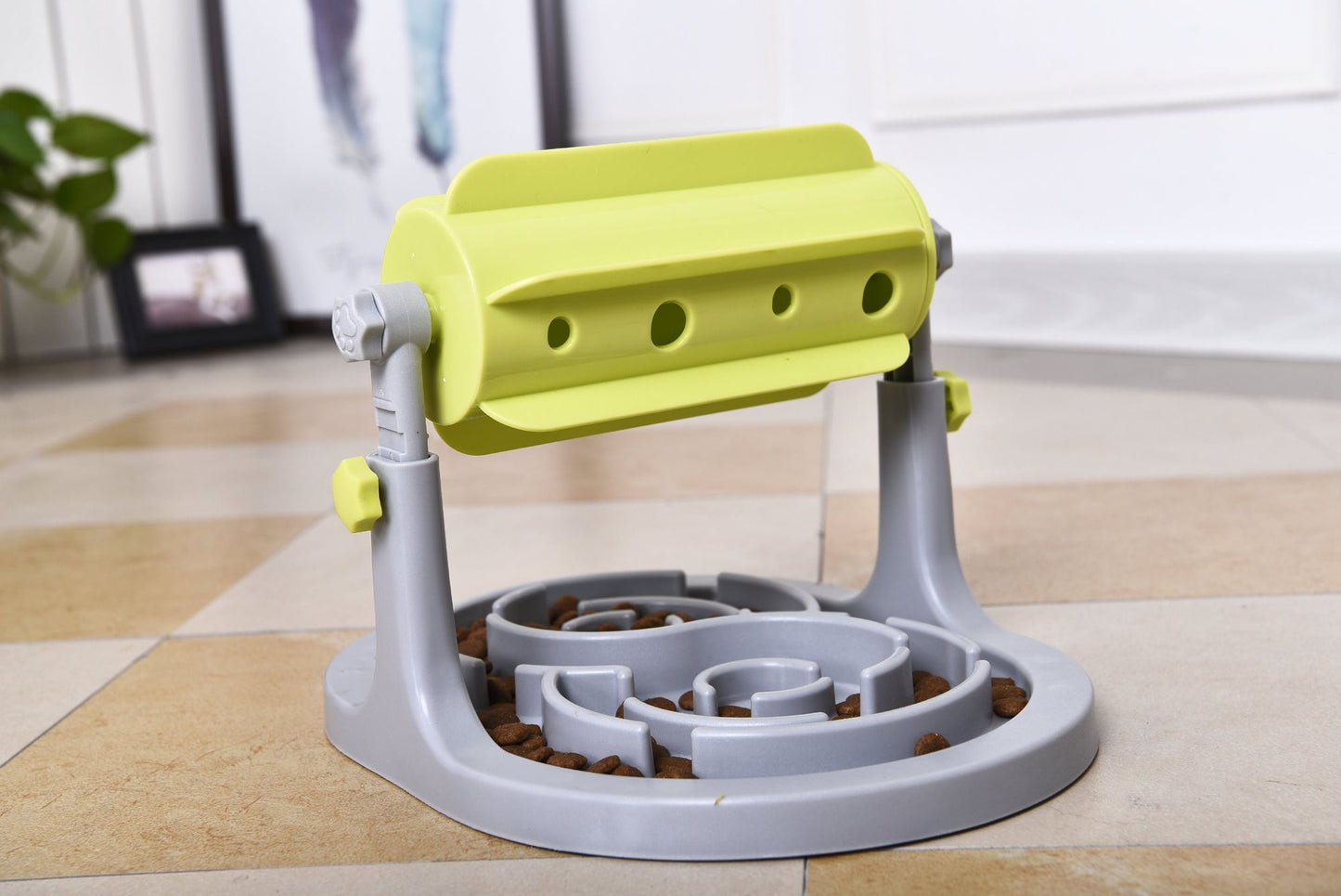 Interactive dog puzzle feeder with rotating yellow drum and gray base to slow down pet eating