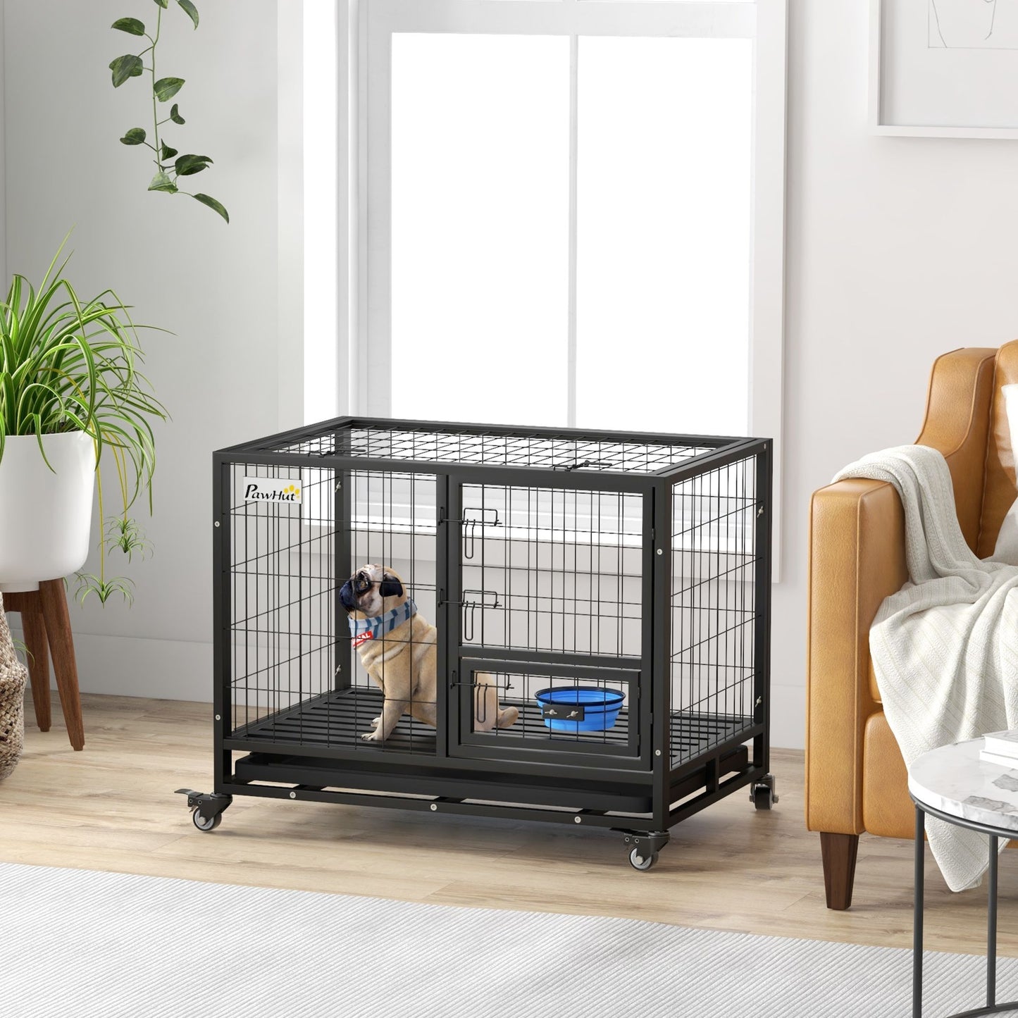 Heavy duty metal dog kennel with wheels housing a small dog and food bowl in a bright living room