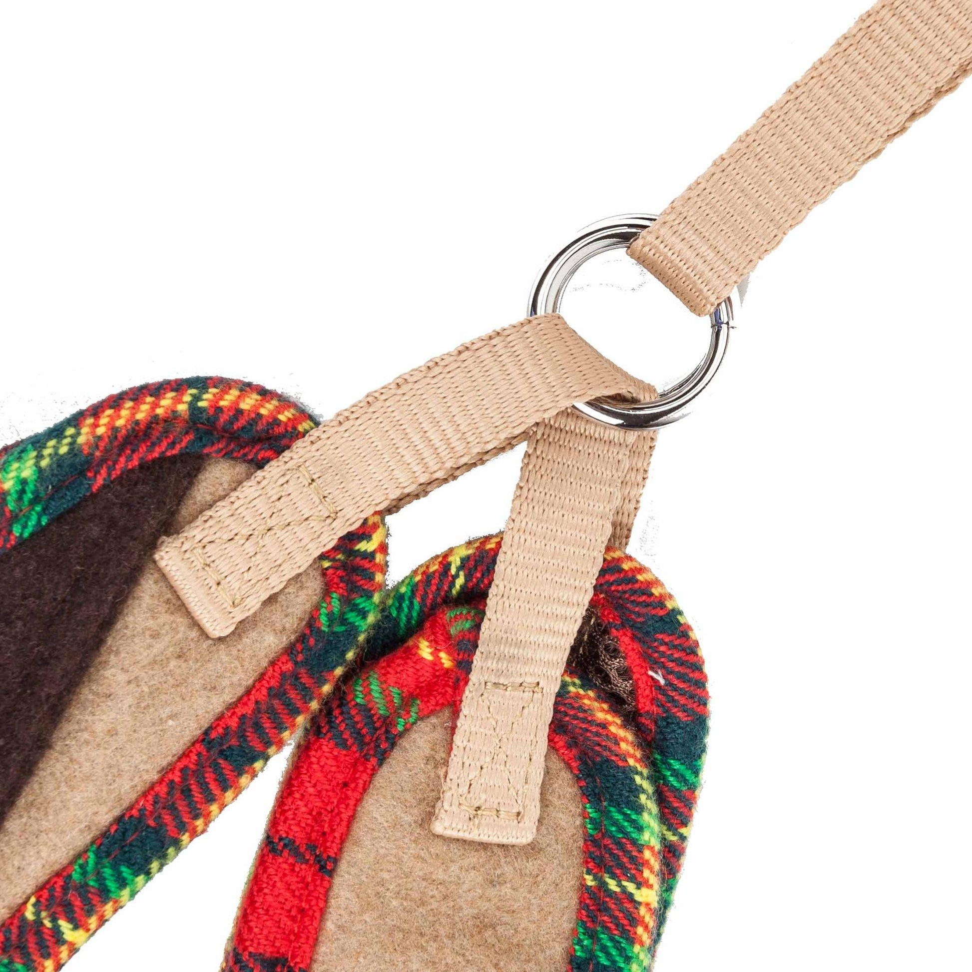 Close-up of dog harness with bowtie featuring beige straps and colorful plaid fabric detailing
