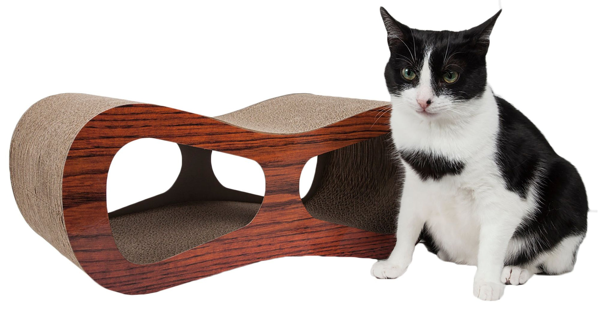 Black and white cat sitting next to premium cat scratcher furniture with wood finish and cardboard surface from PawCounter.com