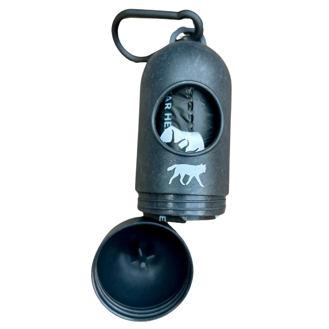 Compact holder with compostable dog poop bags, designed for easy and convenient cleanup on walks