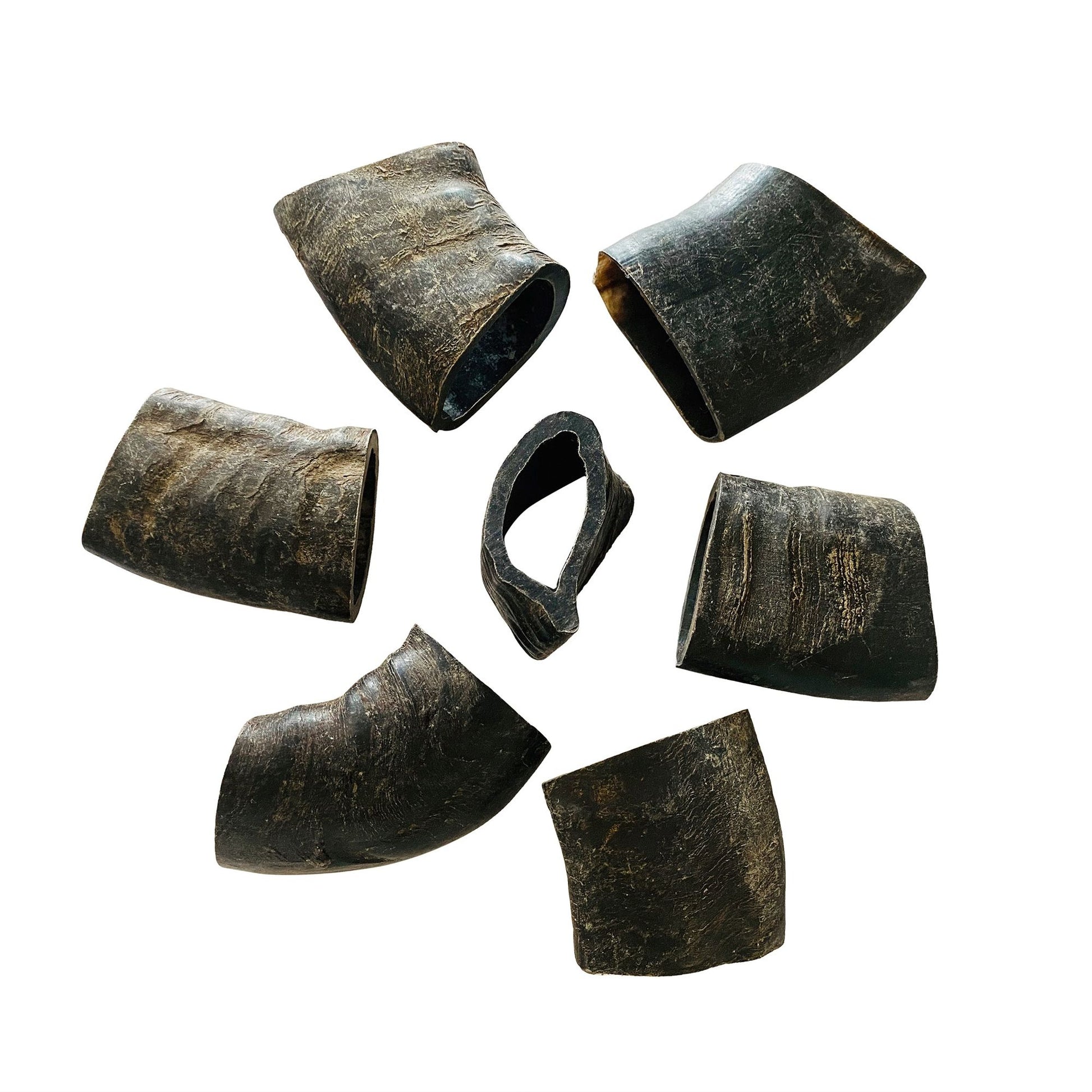 Natural dog chews buffalo horn pieces from PawCounter.com arranged in a circle on white background