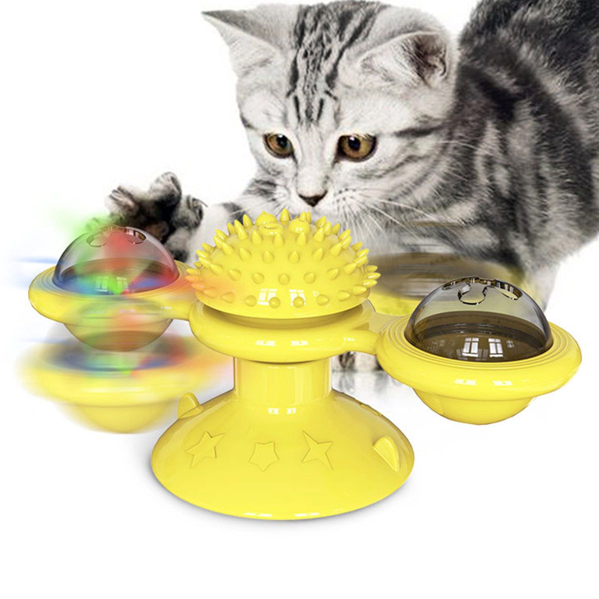 Gray tabby kitten playing with a yellow spinning cat toy with textured center and spinning balls