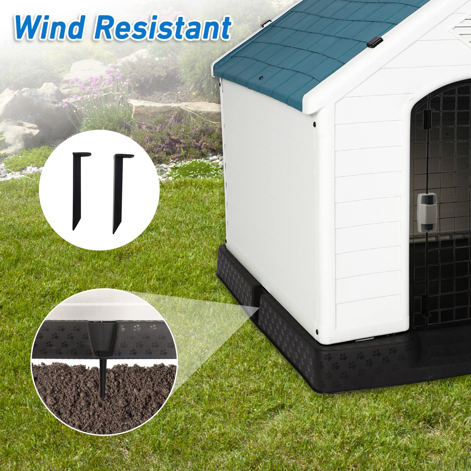 Weatherproof outdoor dog house with wind resistant stakes securing it on green grass