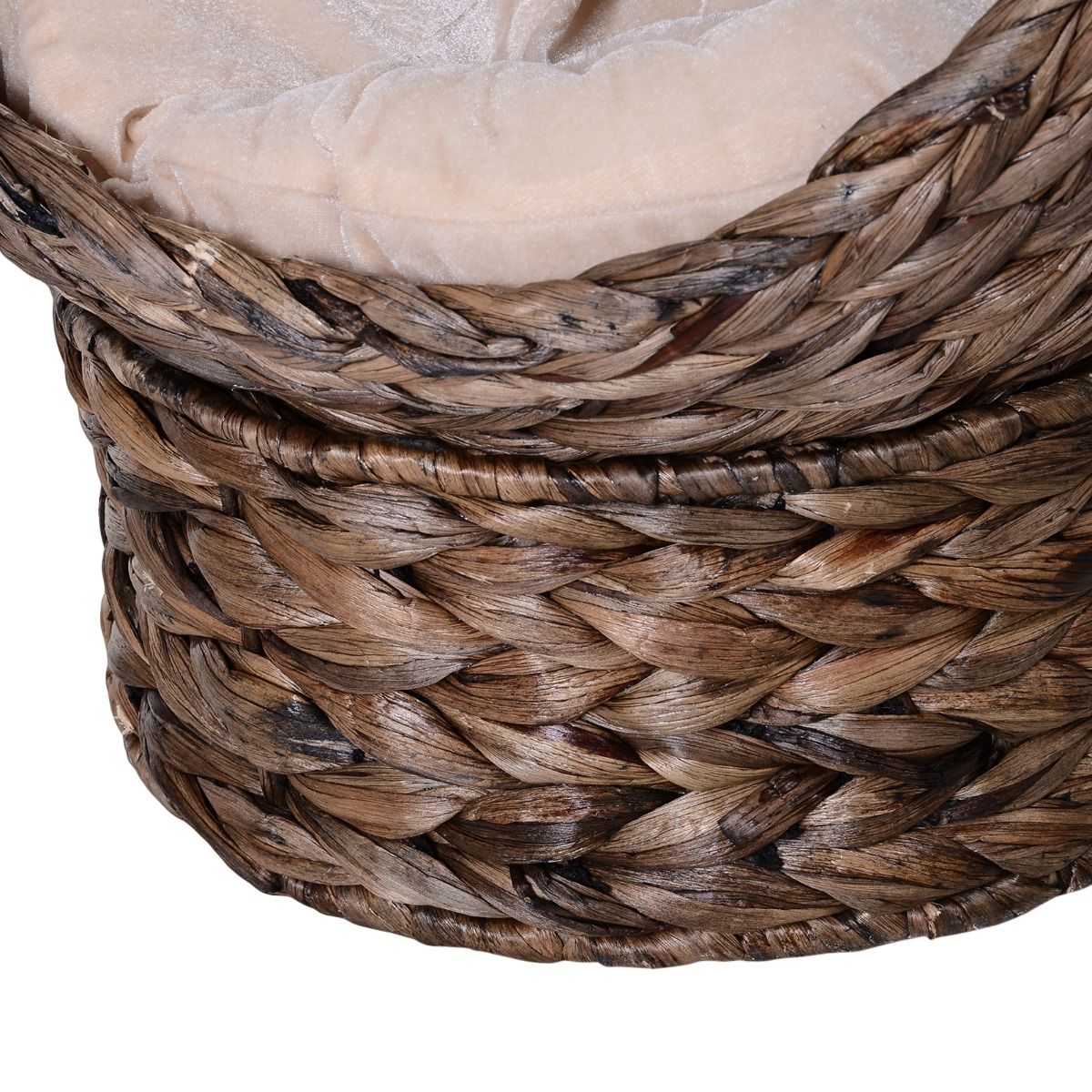 Close-up of a wicker cat bed with cushion showing detailed woven texture and soft beige padding