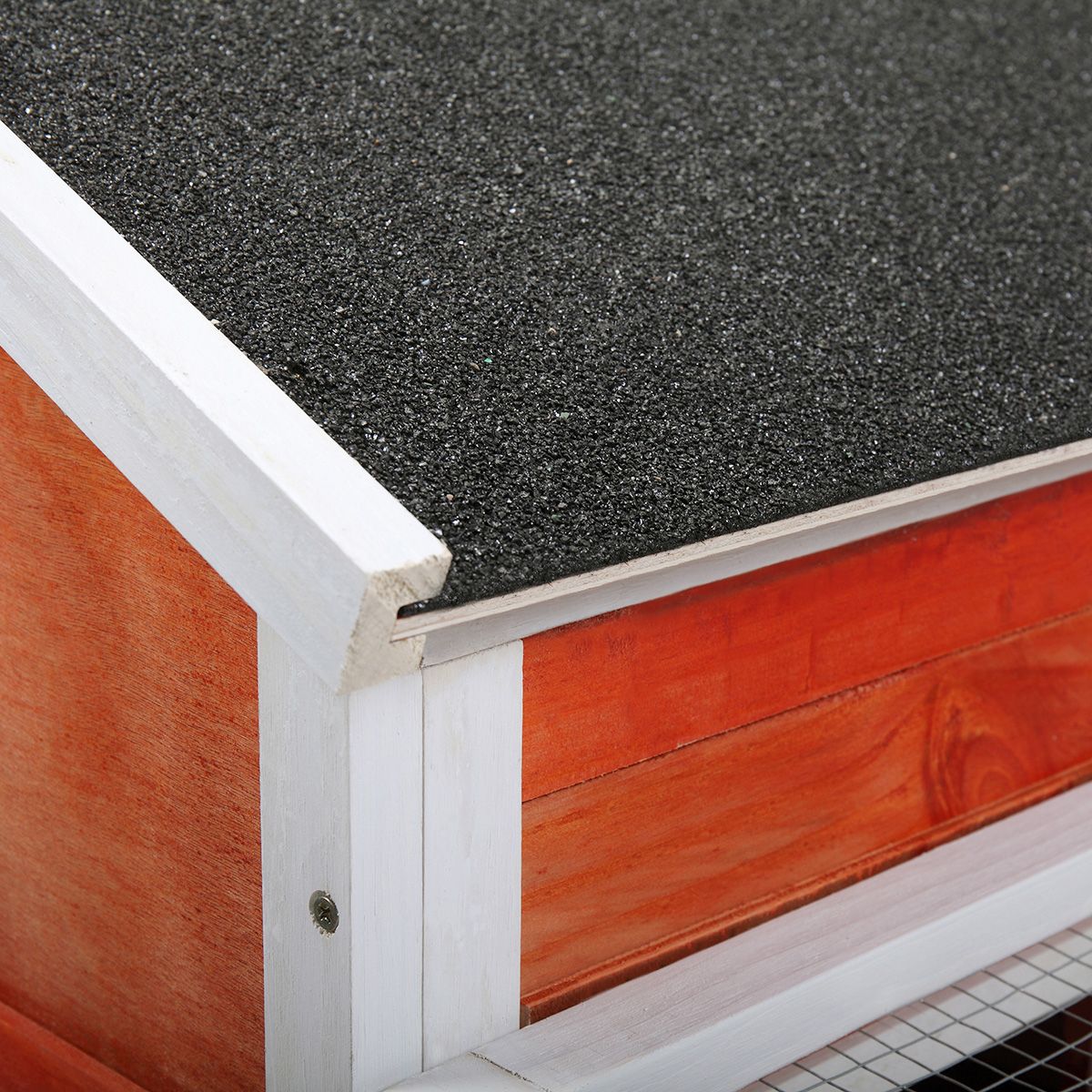 Close-up of roof corner on a wooden 2 story rabbit hutch with white trim and black textured roofing