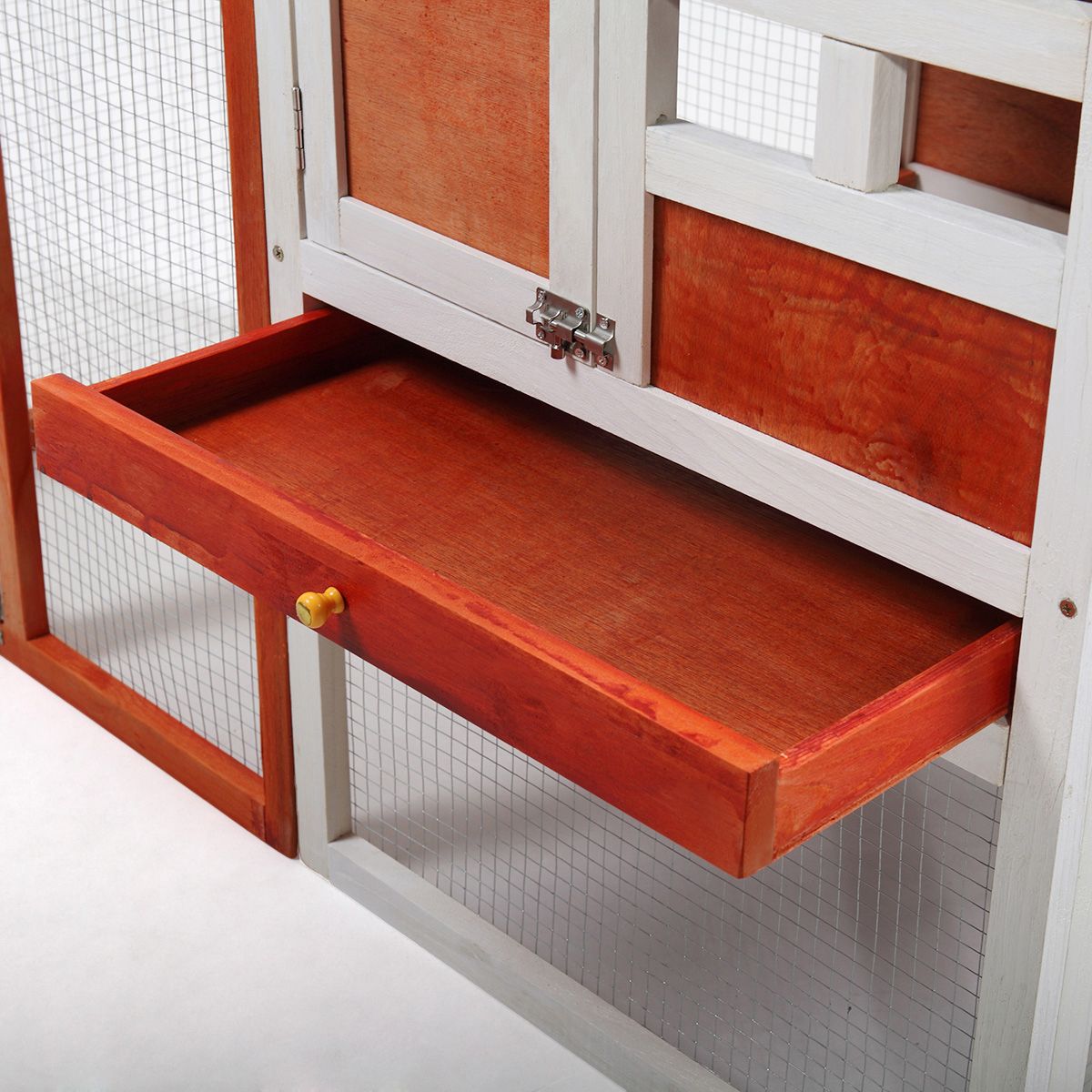 Close-up of pull-out wooden tray inside PawCounter.com 2 story rabbit hutch with wire mesh door