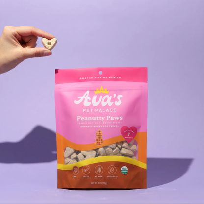 American Pet Supplies Ava's Pet Palace organic dog treats Peanutty Paws in resealable pink and brown bag with heart-shaped treat held in hand