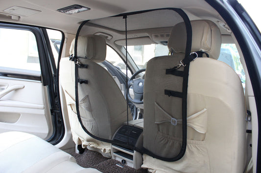 Backseat safety barrier for dogs installed between front seats of car to keep pet secure