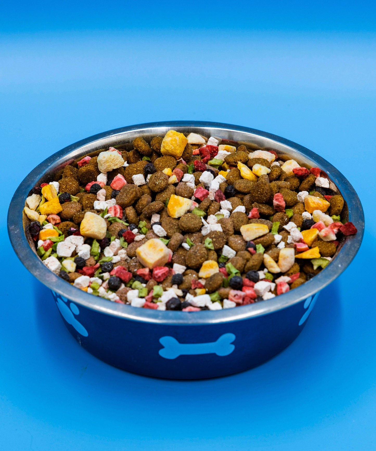 Dog food bowl filled with colorful kibble and treats for pets, designed for nutritional variety