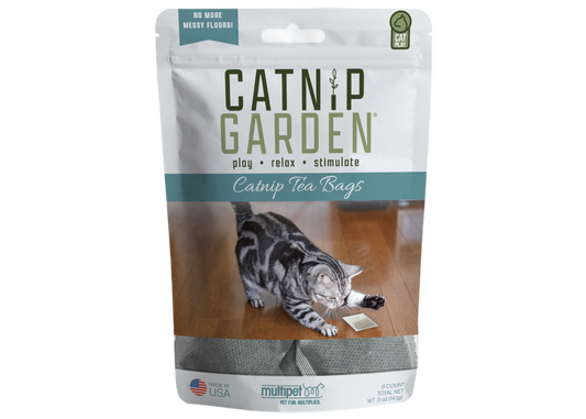 Catnip Garden catnip tea bags for cats by The Family Pet with playful gray tabby cat on wooden floor