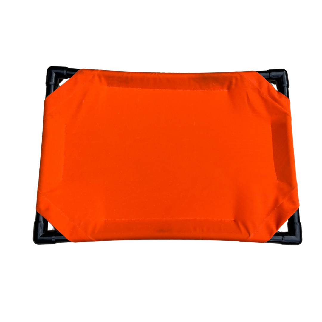 Elevated dog bed in bright orange color with sturdy frame for comfortable pet lounging