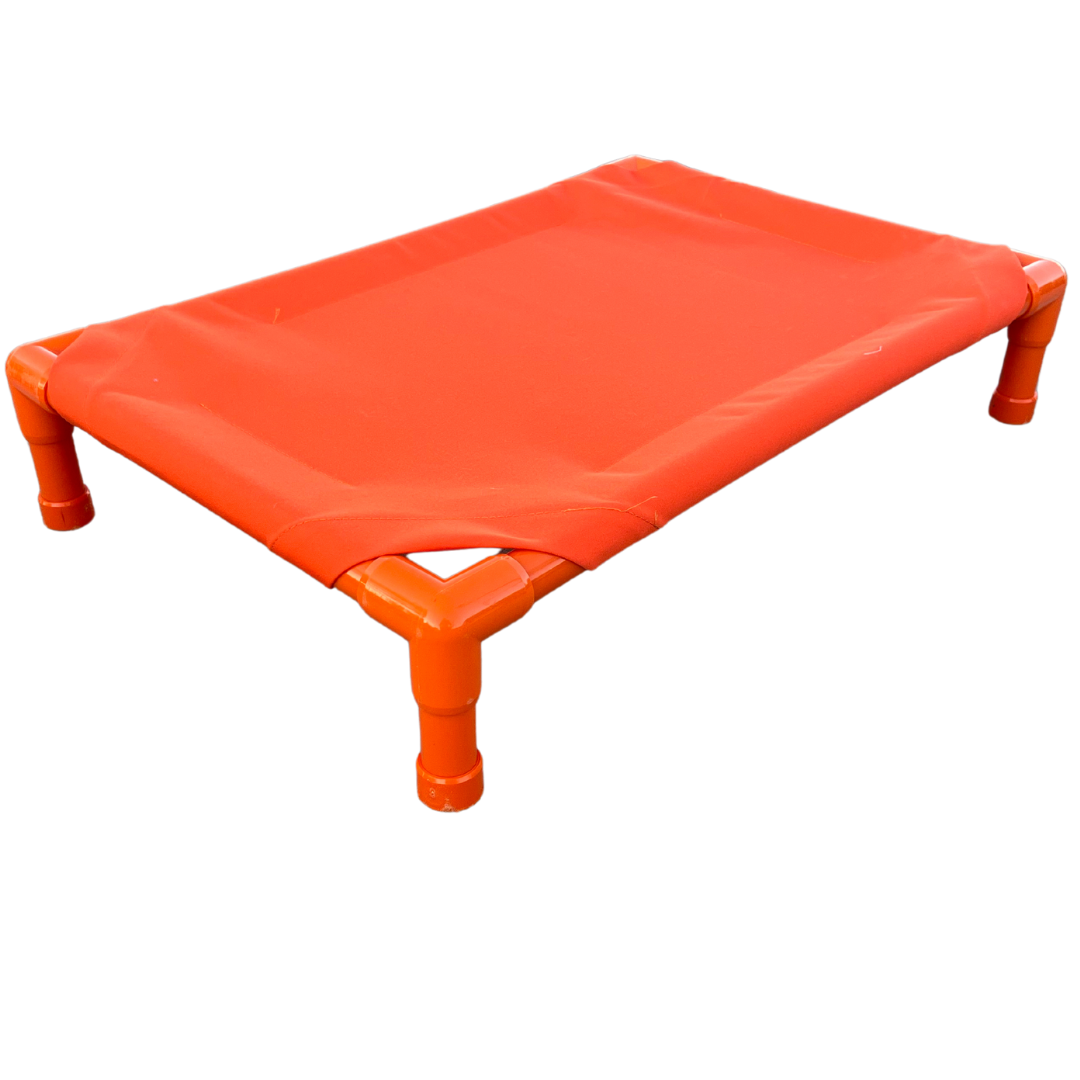 Bright orange elevated dog bed with durable fabric and sturdy frame for pet comfort