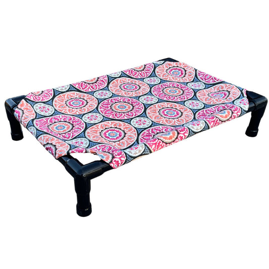 The Family Pet elevated pet bed with colorful patterned fabric and sturdy black frame