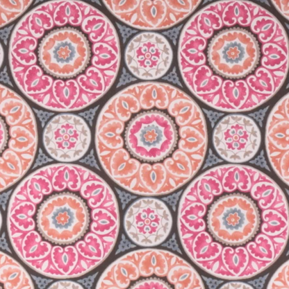 Colorful patterned fabric for elevated pet bed with pink and orange circular floral designs
