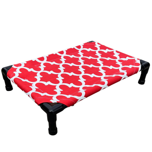 The Family Pet elevated pet bed with red and white patterned fabric and sturdy black legs