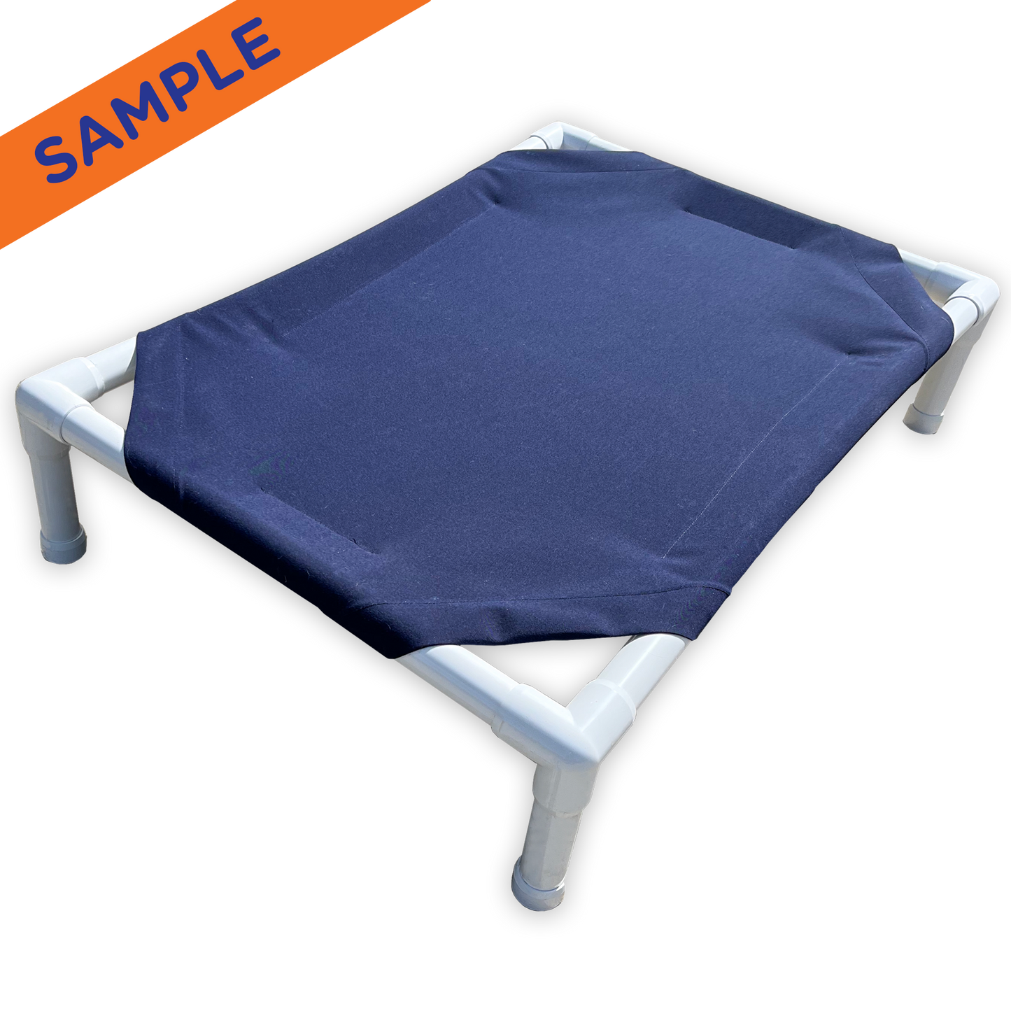 The Family Pet elevated pet bed with white frame and navy blue fabric for comfortable pet lounging