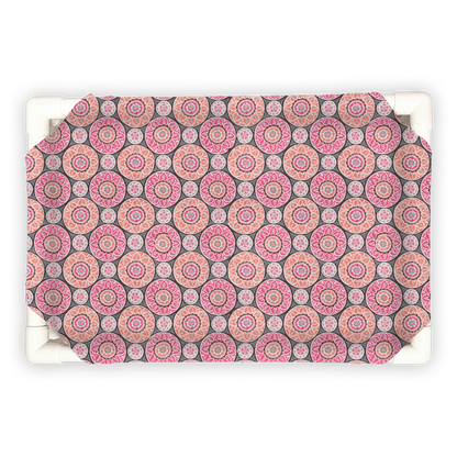 The Family Pet elevated pet bed with pink and gray circular patterned cover on white frame