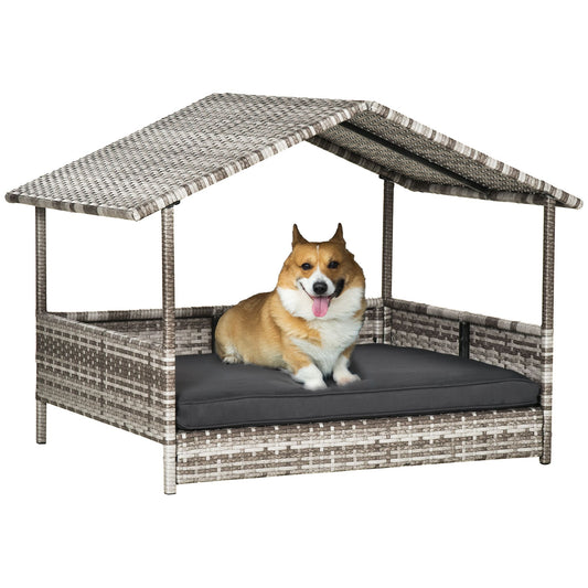 Elevated wicker dog house with roof and black cushion featuring a happy corgi lying inside