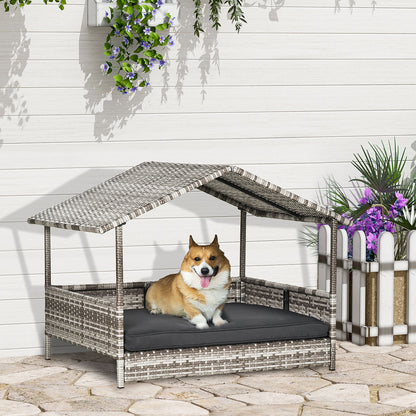Elevated wicker dog house with roof and black cushion featuring a happy corgi sitting inside