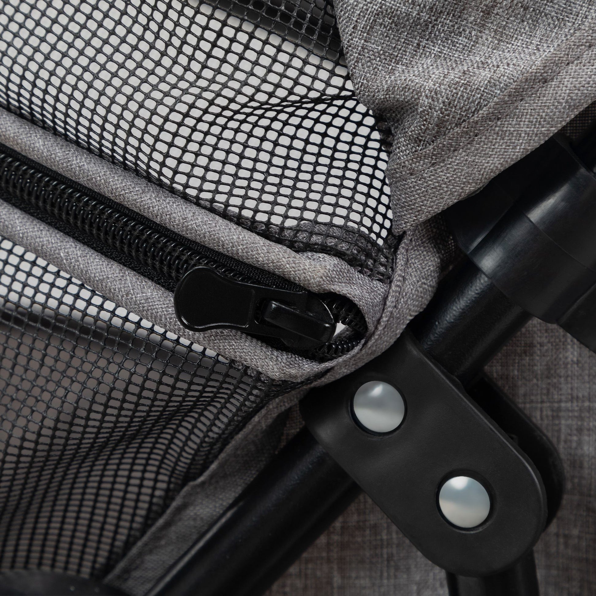 Close-up of zipper and joint on PawCounter.com foldable pet stroller with mesh and fabric materials