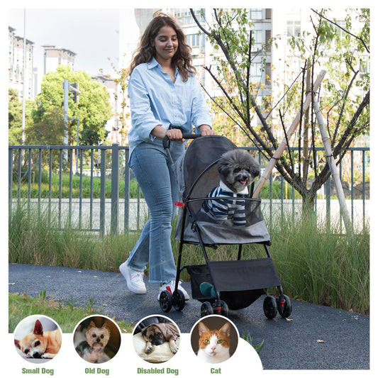 Woman pushing a foldable pet stroller with a small dog inside outdoors in a park setting