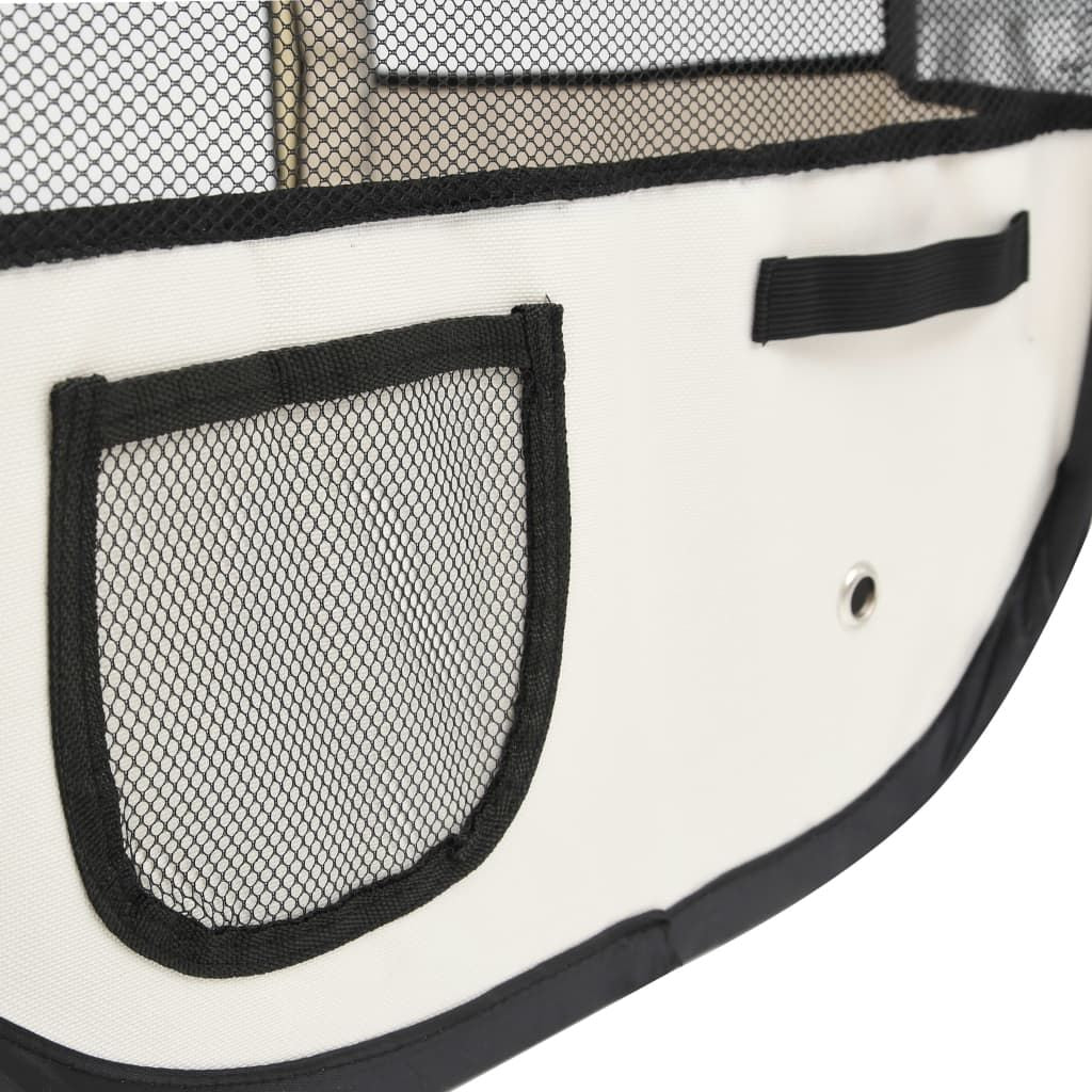 Close-up of foldable dog playpen fabric with mesh pocket and ventilation holes in white and black