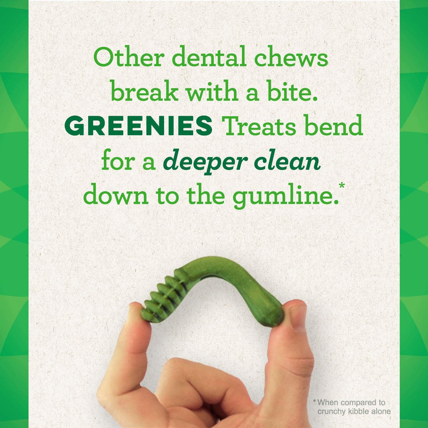 Hand holding a Greenies dental treat for large dogs, designed for a deeper clean down to the gumline.