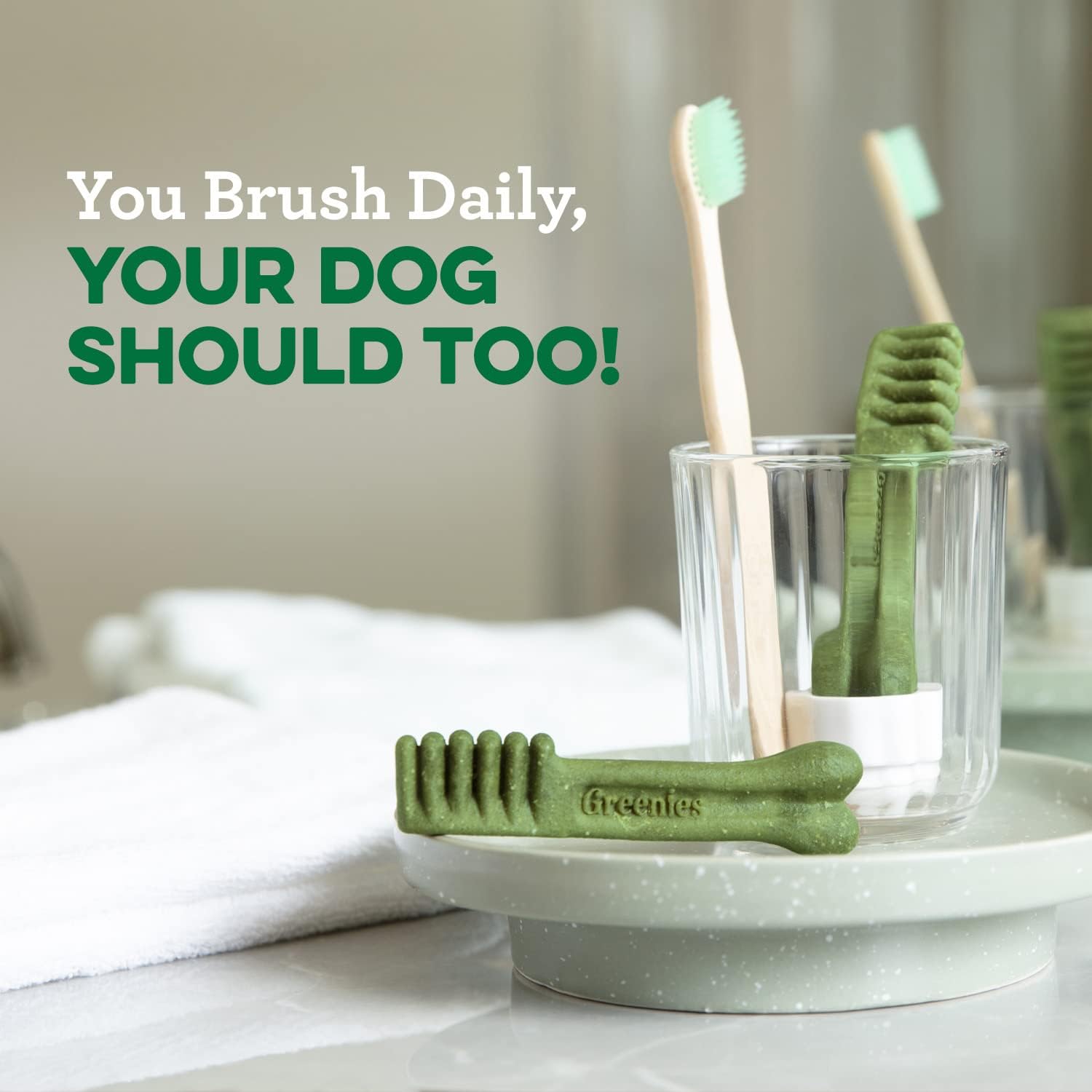 Greenies dental treats for large dogs displayed with toothbrushes in a stylish bathroom setting