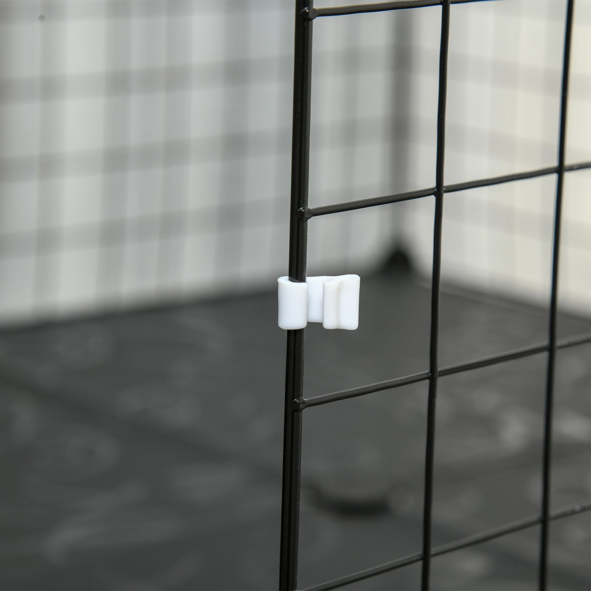 Close-up of a latch on a guinea pig playpen with door, designed for easy access and safety