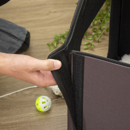 Hand adjusting the opening of a heated cat house for outdoor use designed for easy access and comfort